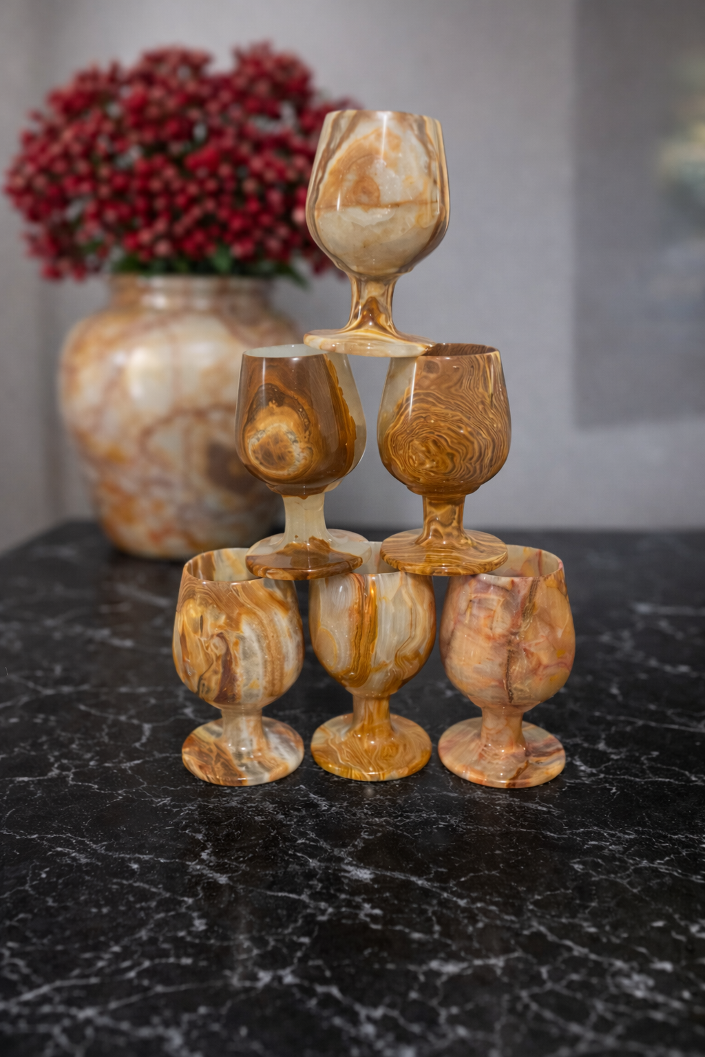 Handcrafted onyx wine goblets styled on dark marble tabletop