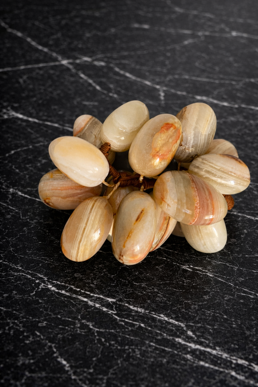 Natural onyx grapes decorative set styled on dark marble surface