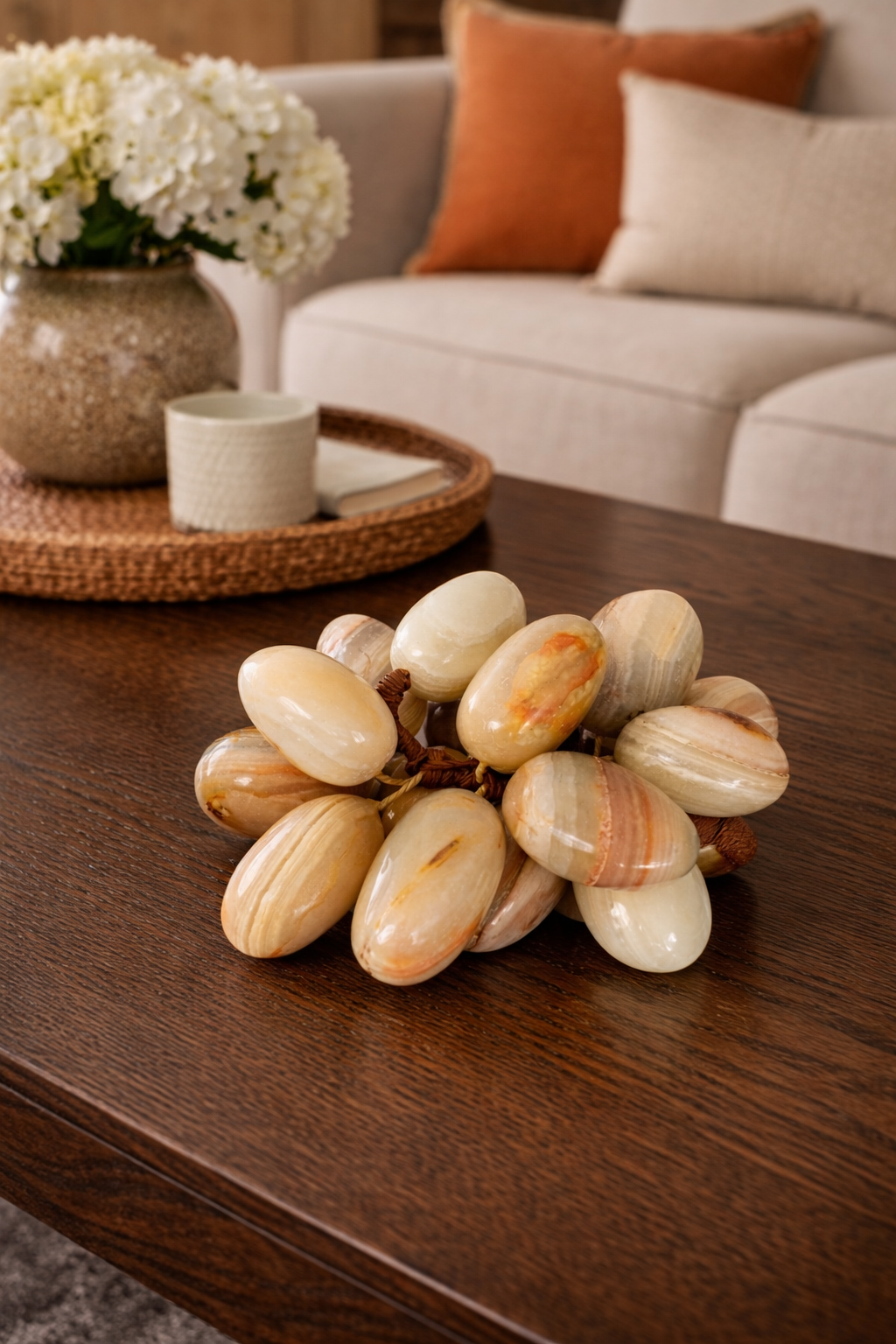 Polished natural onyx grapes decor arranged on coffee table