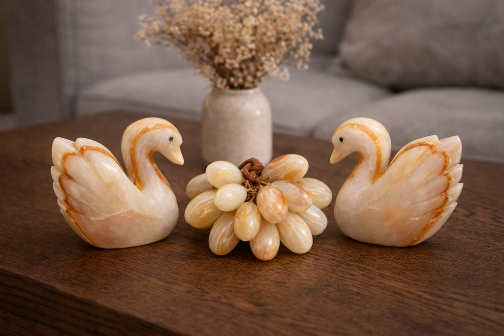 Natural onyx swan figurine styled alongside matching onyx grape decor