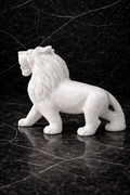 Luxury white marble lion statue with detailed mane carving on dark marble background