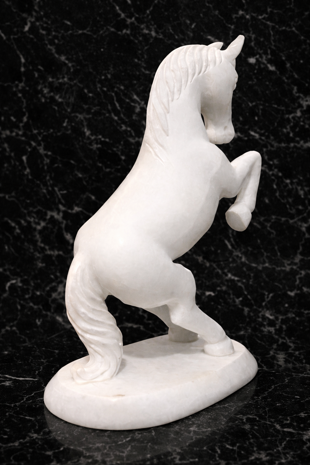Rare view of decorative marble horse sculpture symbolising strength and success on marble surface