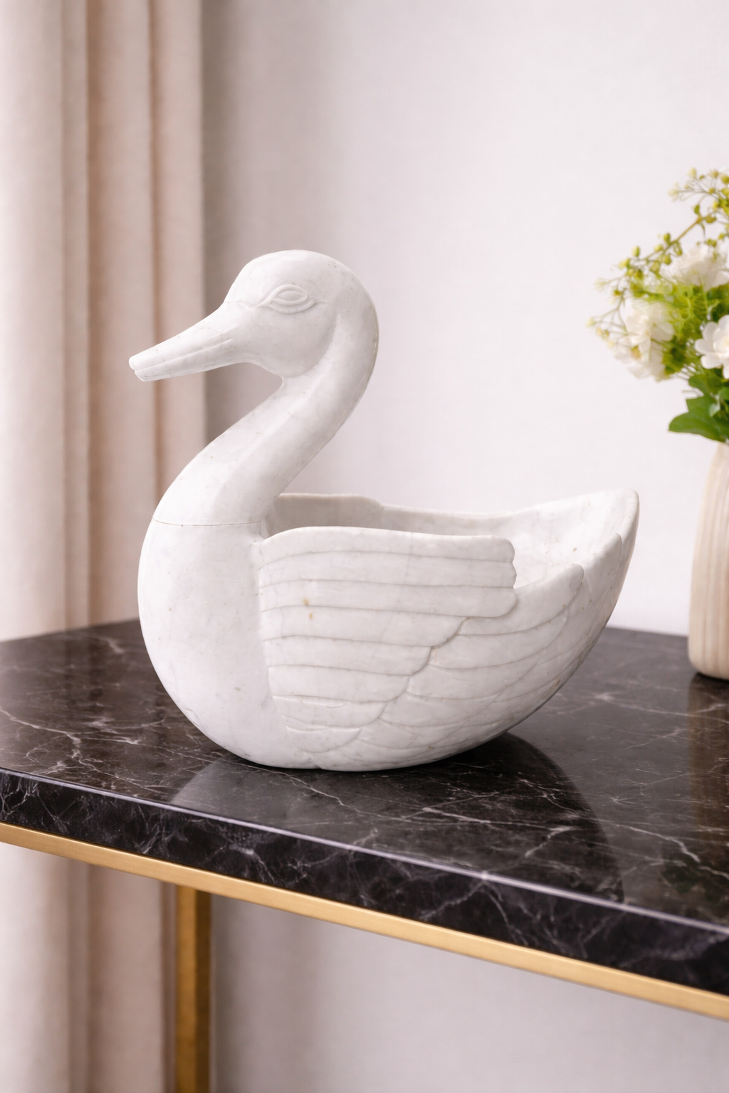 Hand-carved marble duck bowl on black marble table, luxury statement centrepiece NZ