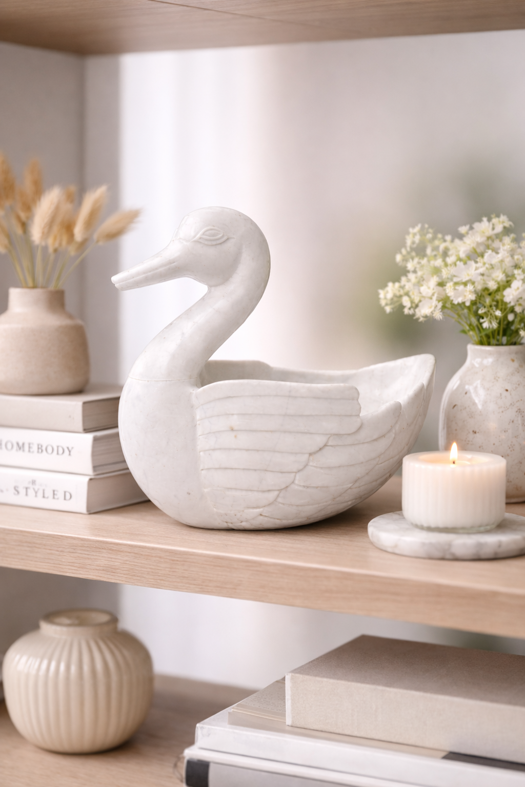 Polished white marble duck bowl styled on décor shelf, modern stone home accent NZ