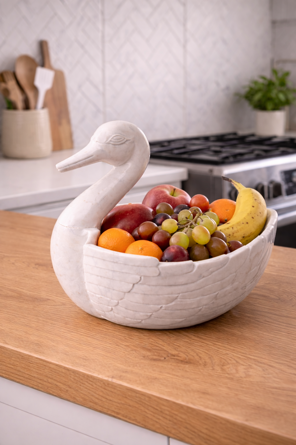 Hand-carved white marble duck bowl used as fruit holder on wooden table, luxury stone décor NZ
