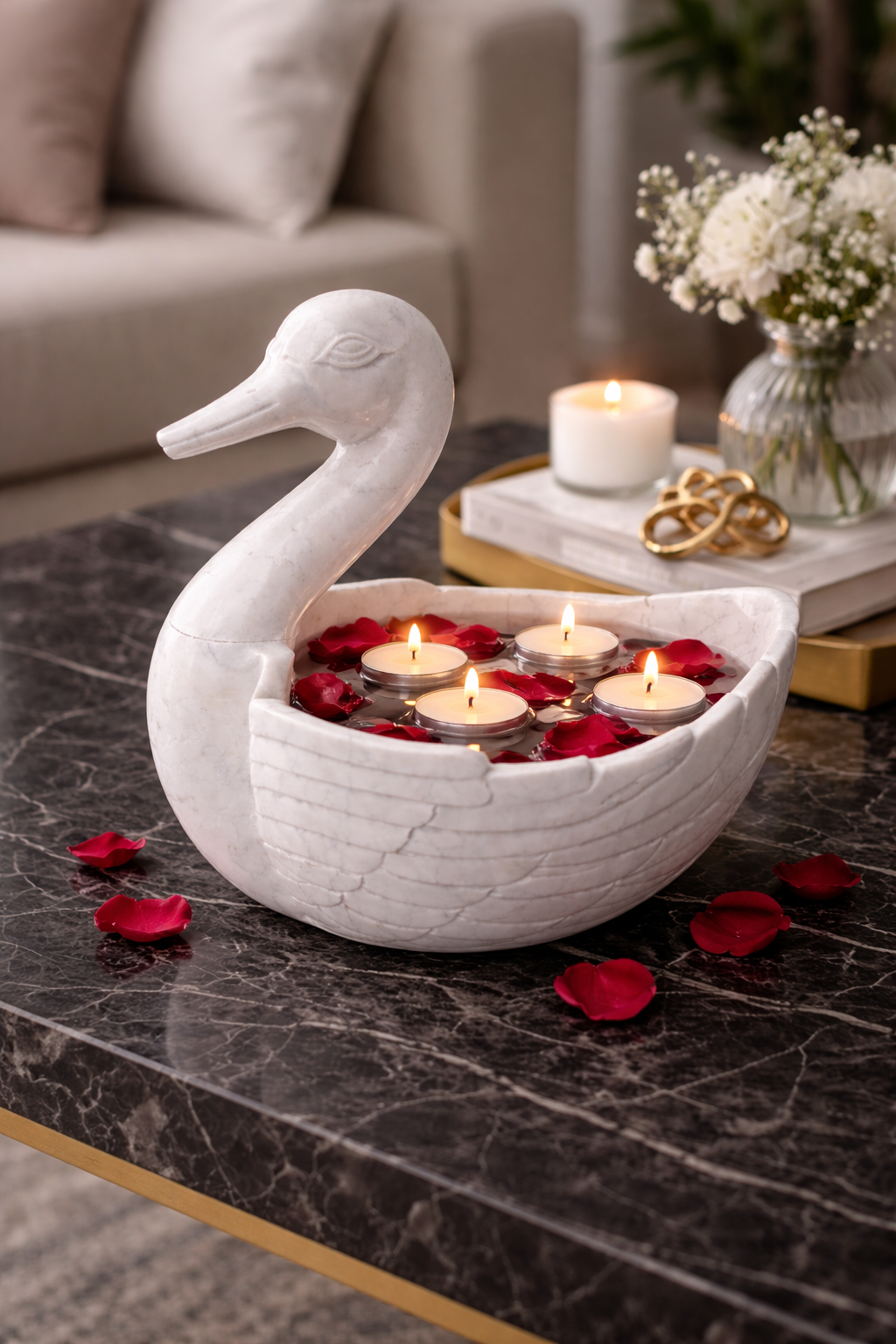 Hand-carved white marble duck bowl with floating candles and rose petals on black marble table, luxury festive décor NZ