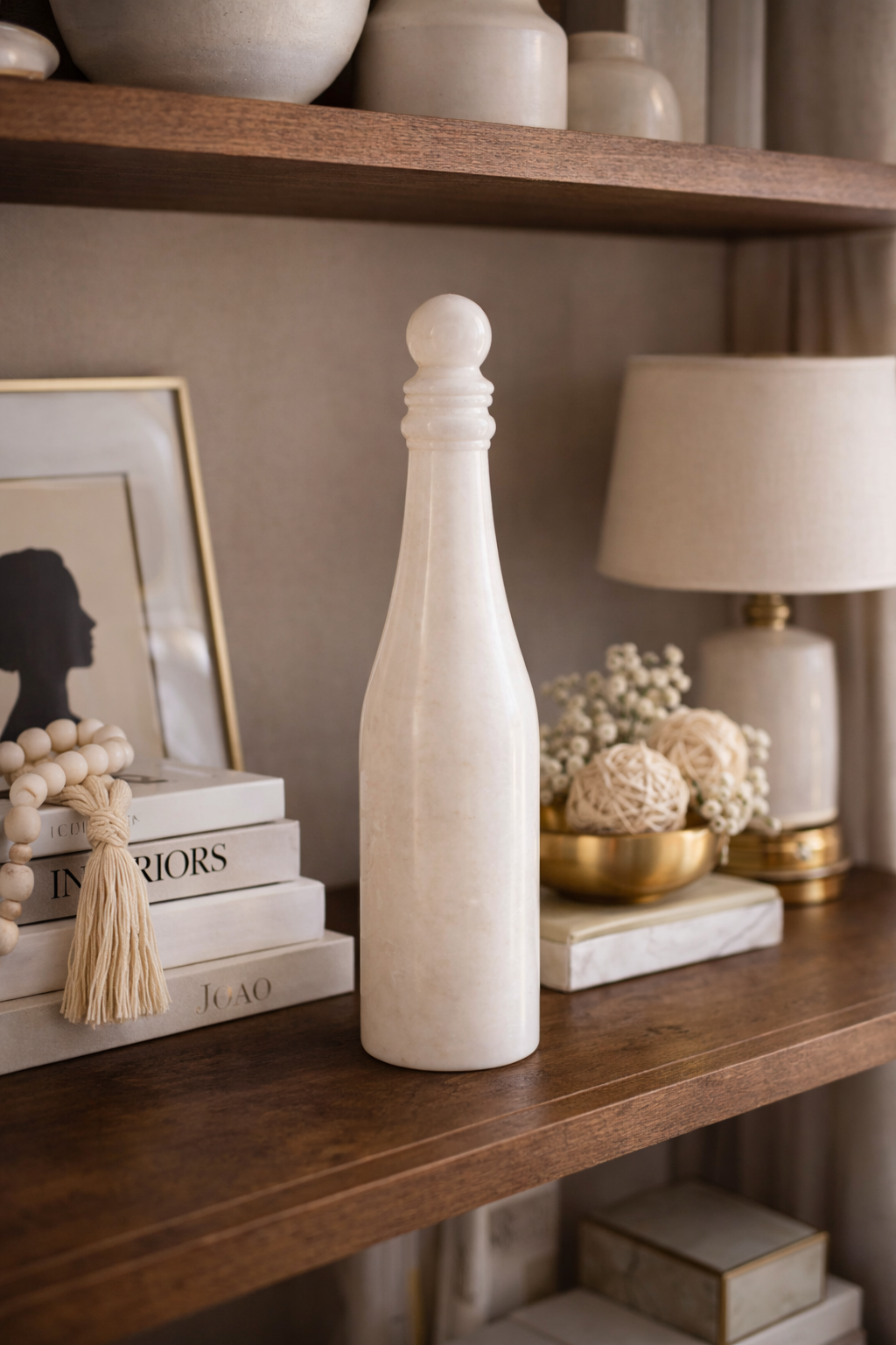 White marble wine bottle sculpture displayed on decor shelf – luxury natural stone home styling NZ