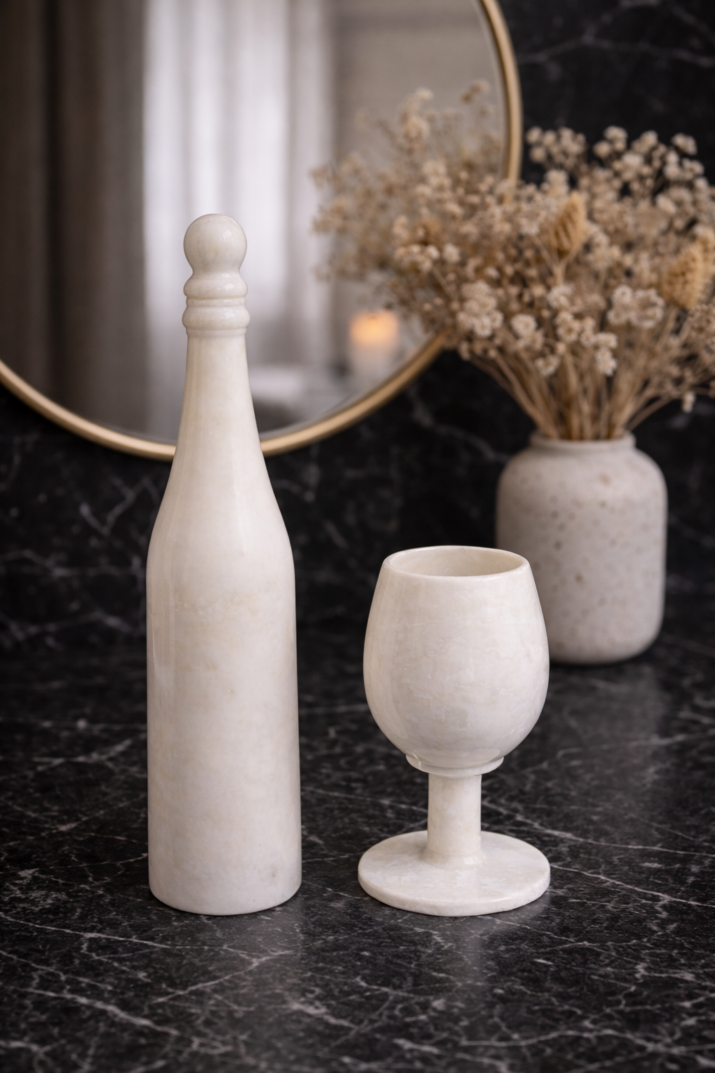 Hand-carved white marble wine bottle and goblet styled with mirror and floral vase on black surface – premium home decor NZ