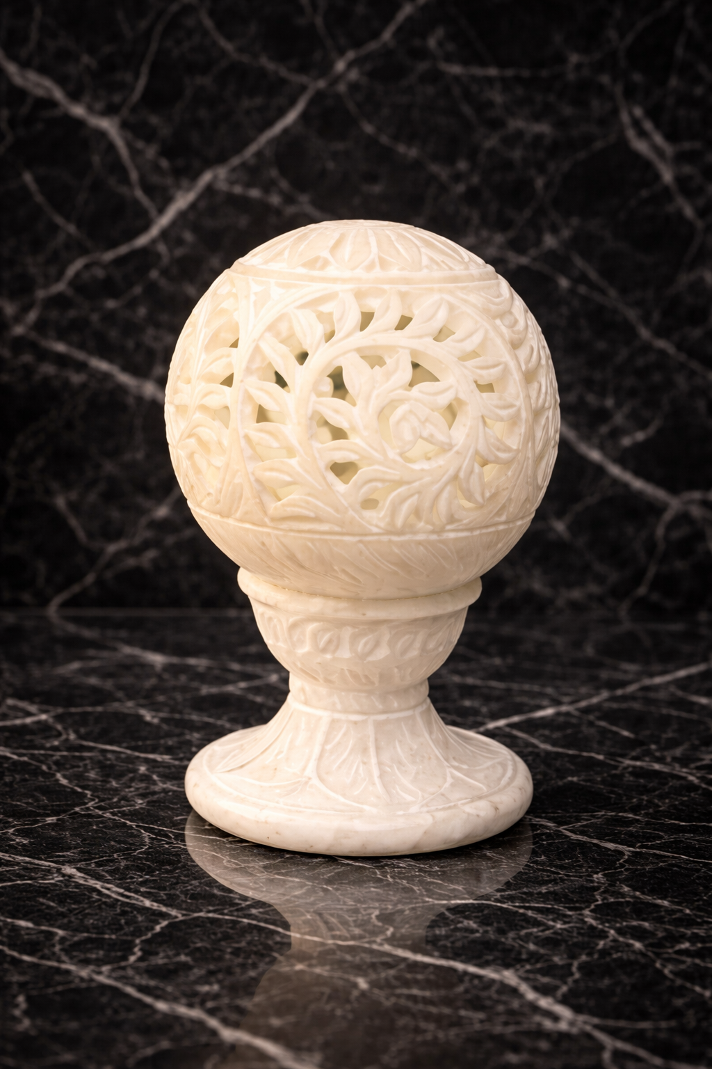 0.36 kg hand-carved white marble floral tealight holder glowing on black marble surface