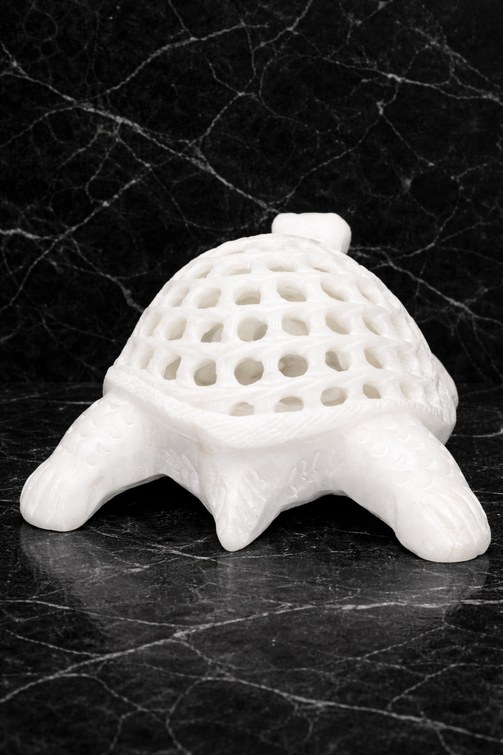 Rare view of hand-carved marble turtle statue with intricate open shell pattern