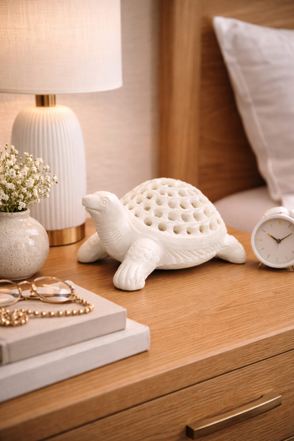 Luxury marble turtle statue displayed on bedside table with floral arrangement