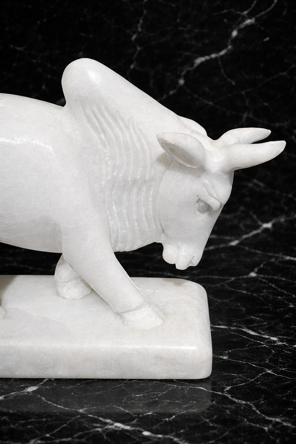 Handcrafted white marble bull figurine with detailed carving