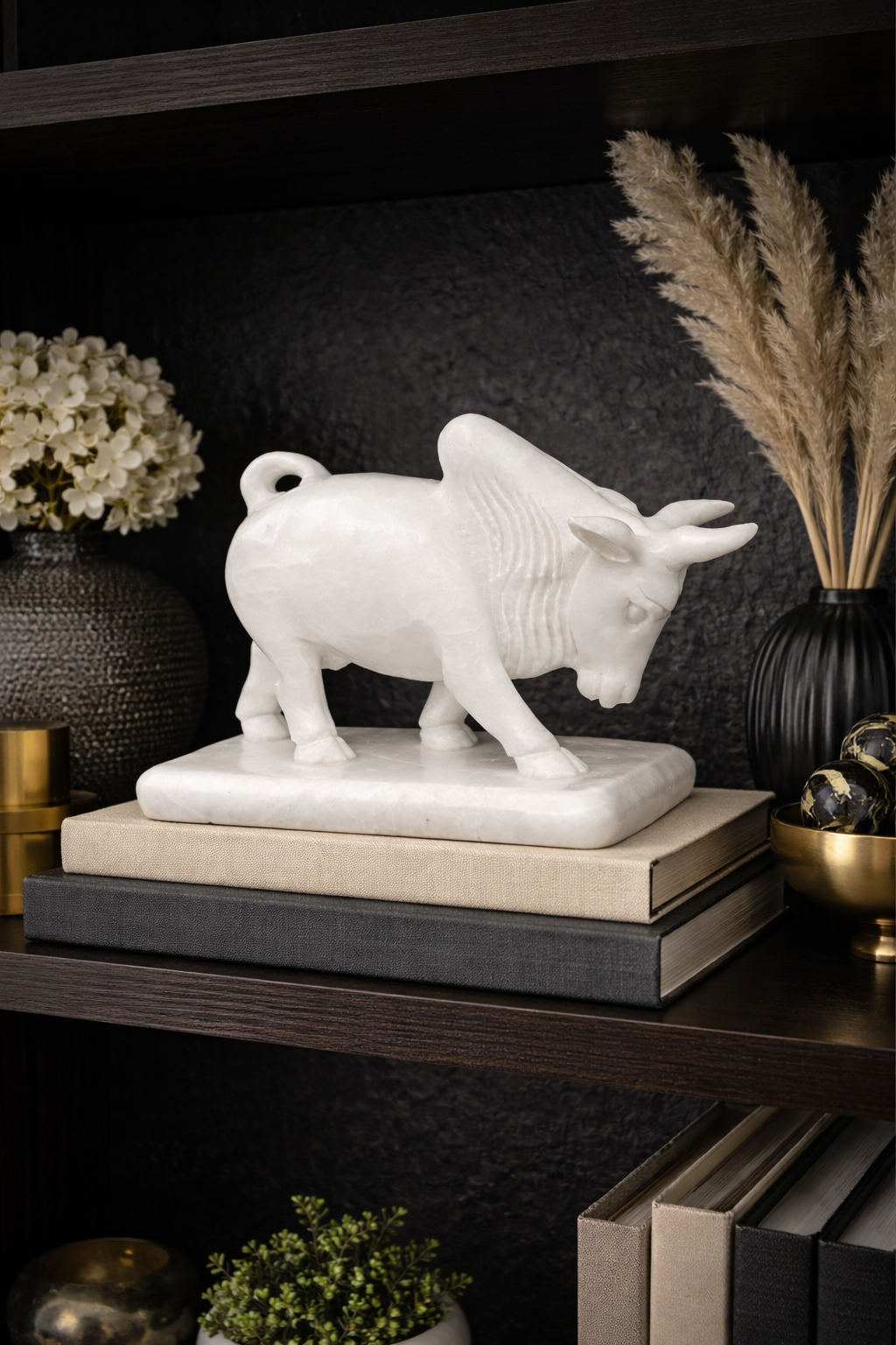 Decorative marble bull sculpture styled on bookshelf with modern interior accents nz
