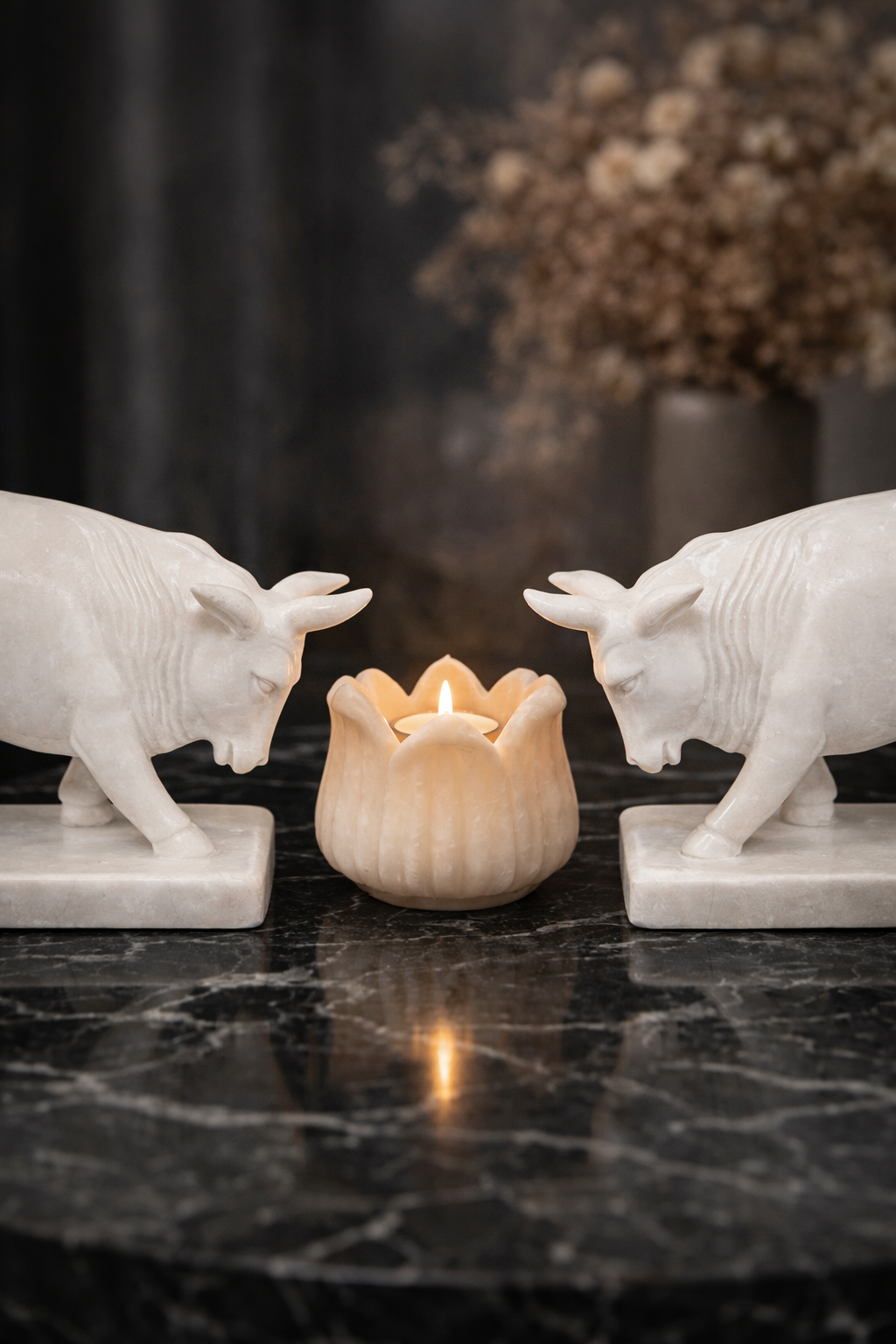 Pair of hand-carved white marble bull sculptures with lotus candle holder centrepiece on marble table