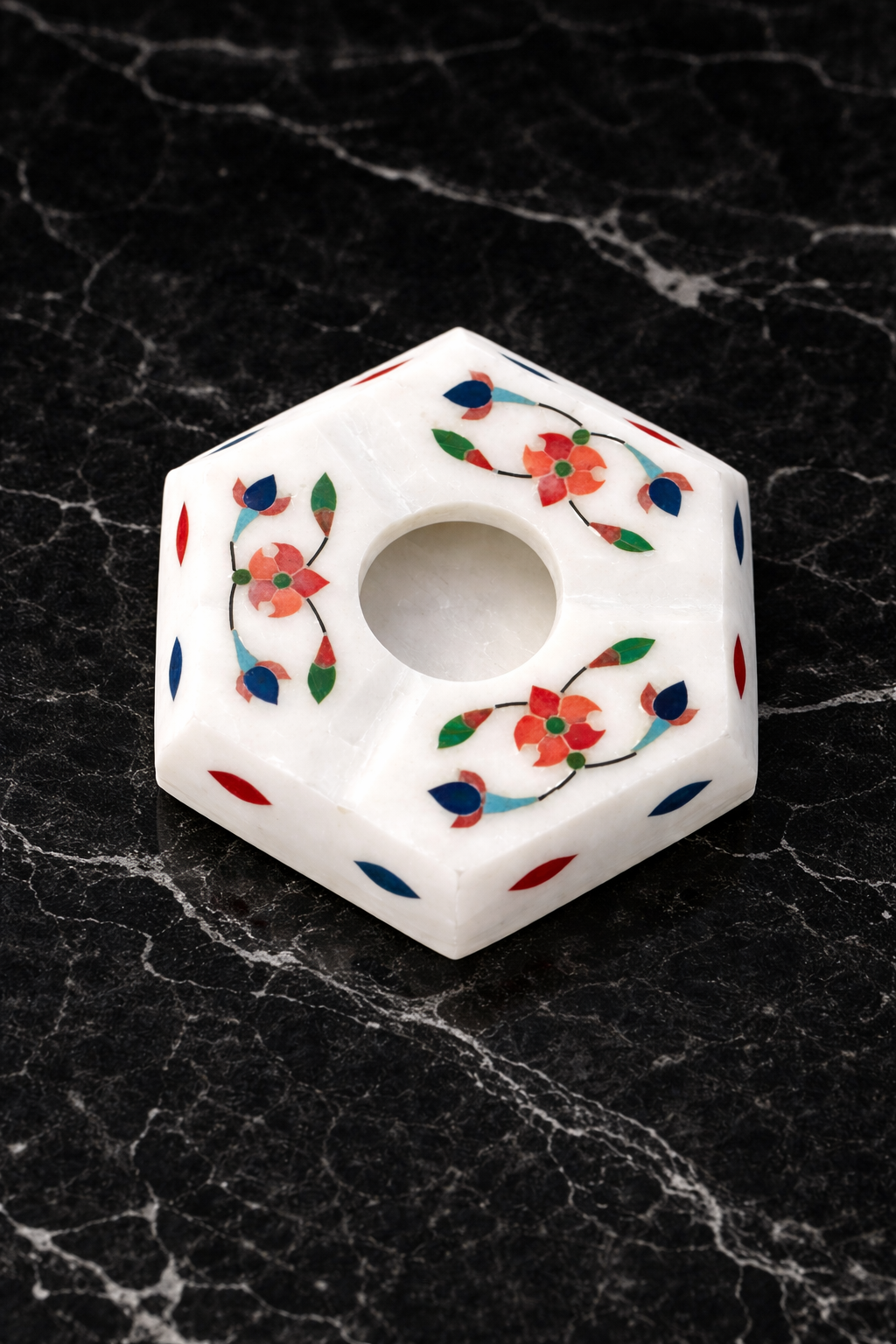 Handcrafted white marble hexagon ashtray with red and blue floral inlay on black marble surface