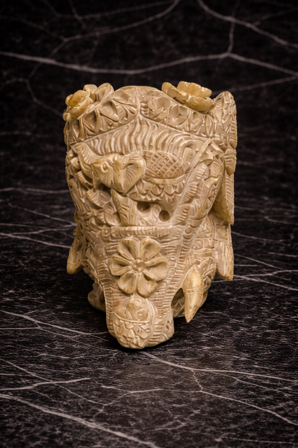 0.343 kg Front view of hand carved soapstone elephant sculpture with intricate floral detailing and hidden inner elephant design