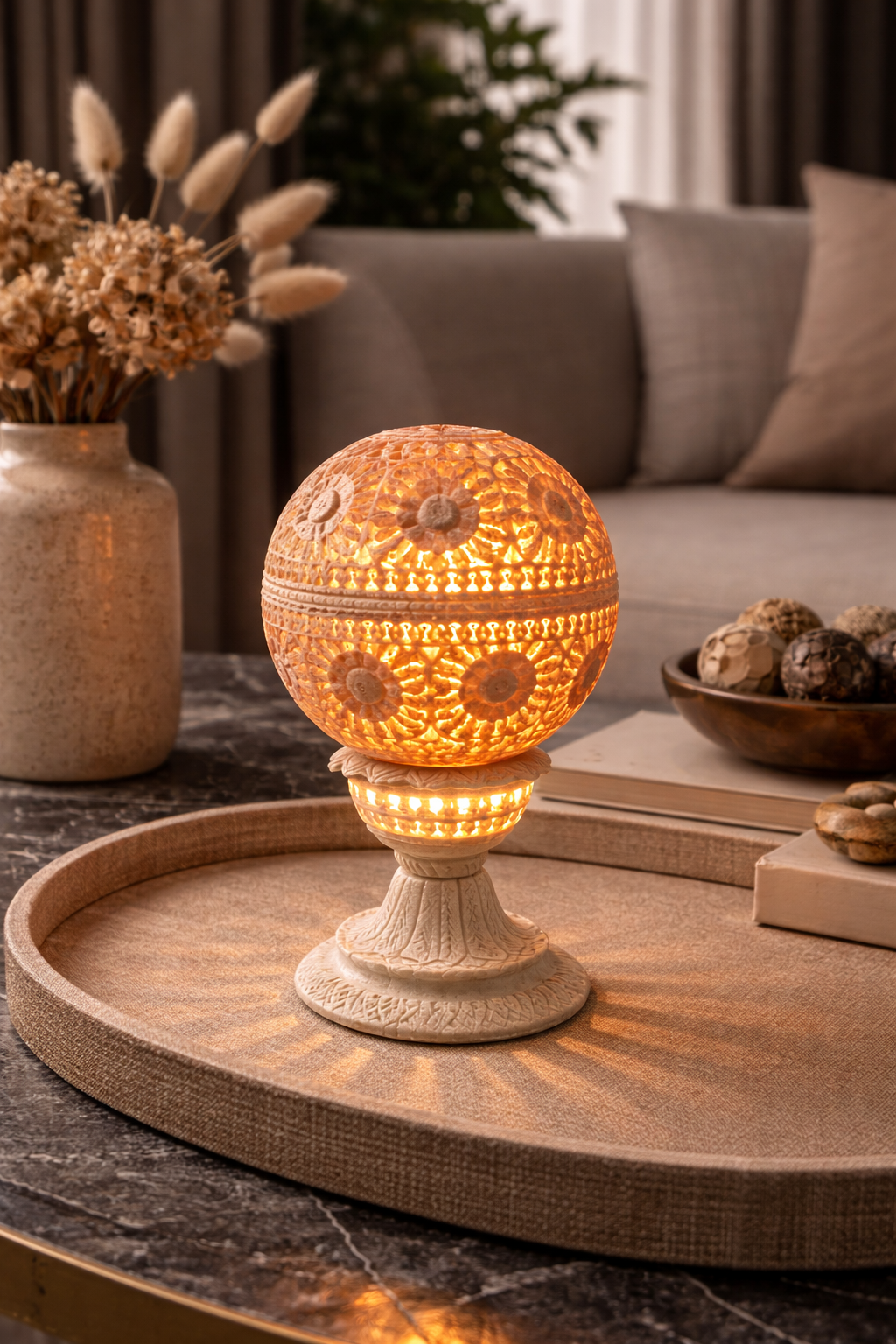 Decorative soapstone tealight holder illuminating console table with colourful glow