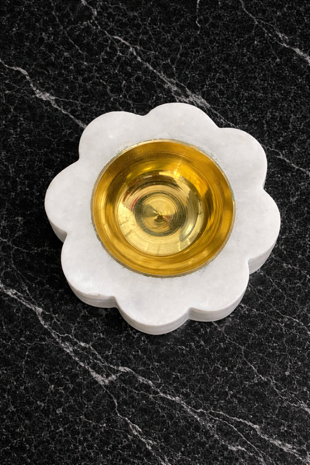 Close-up detail of lotus carving on round marble tealight holder