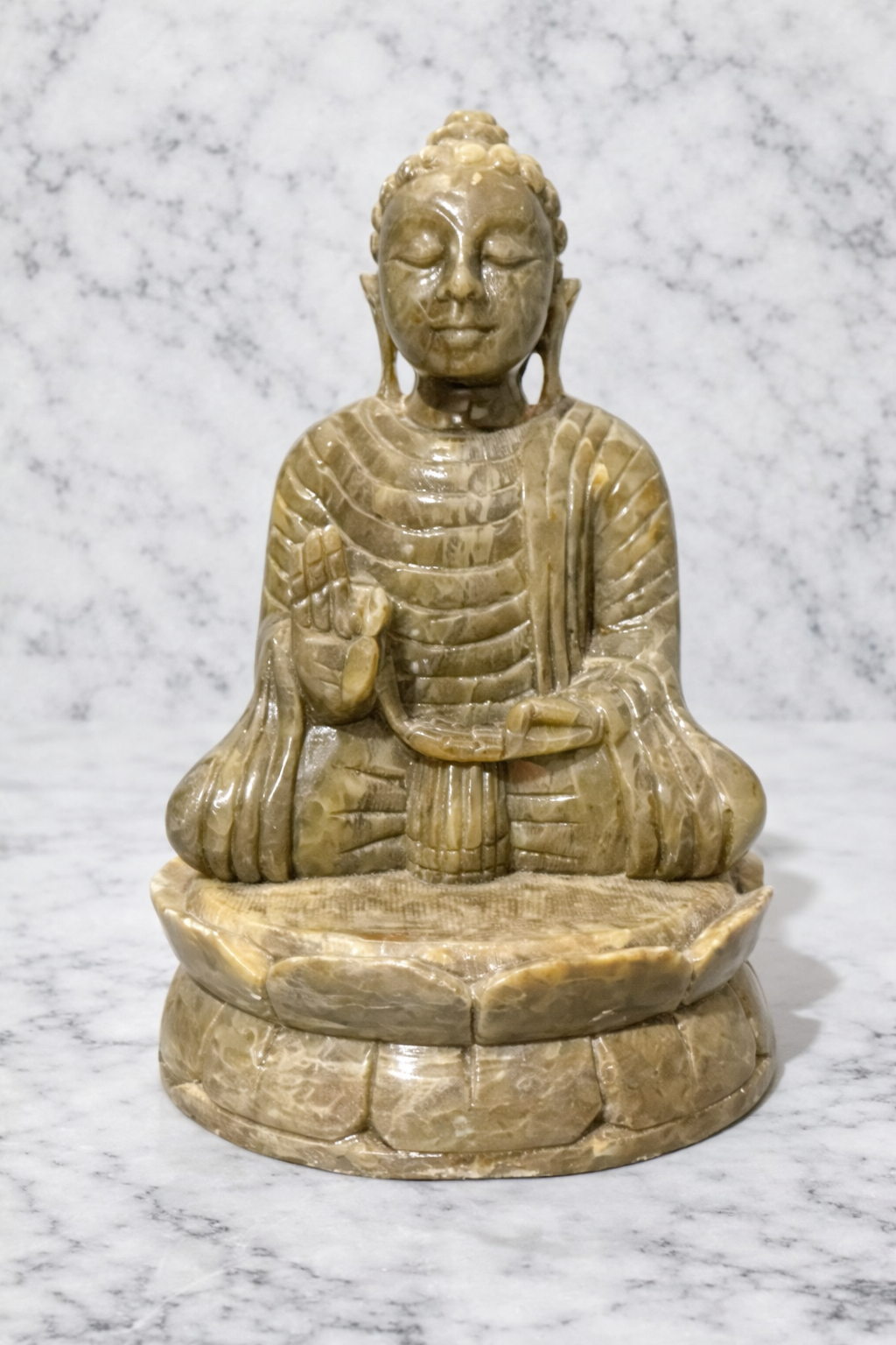 Polished soapstone Buddha statue seated on lotus base, natural stone meditation décor.