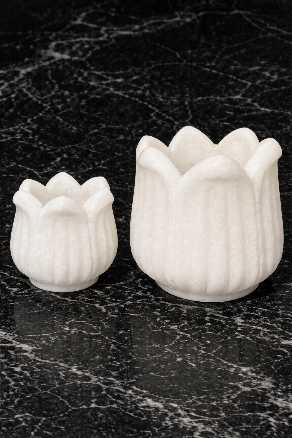 Hand-carved polished white marble lotus tealight holder on dark marble surface, luxury stone home décor in NZ