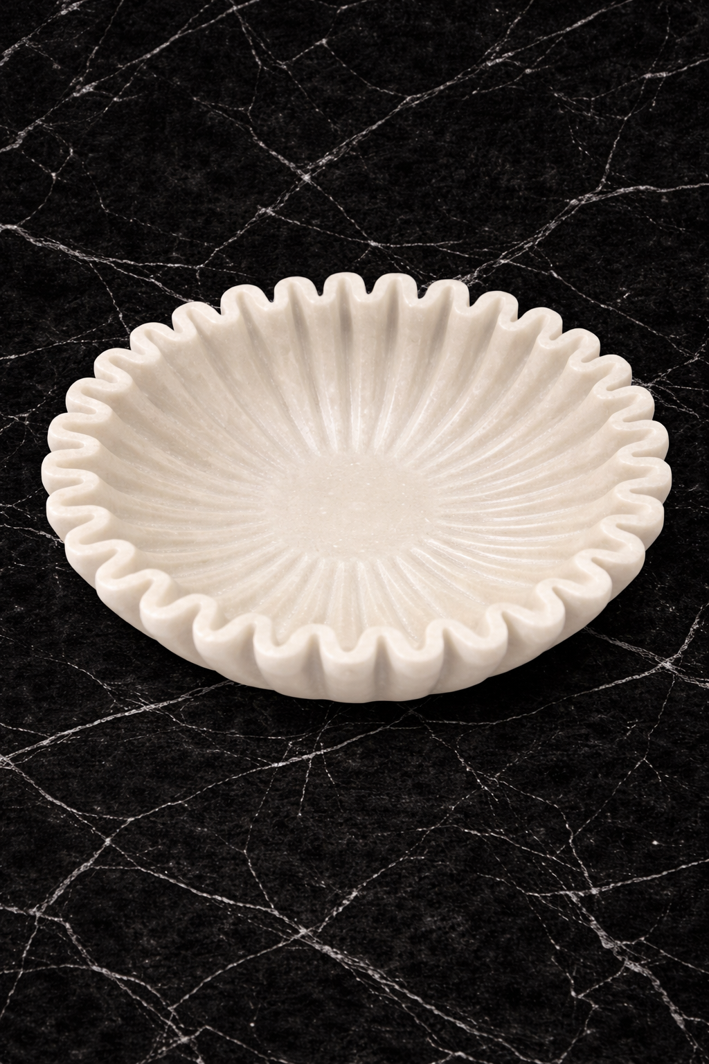 Polished white marble fluted bowl with zigzag rim on black marble table, premium decorative centrepiece NZ