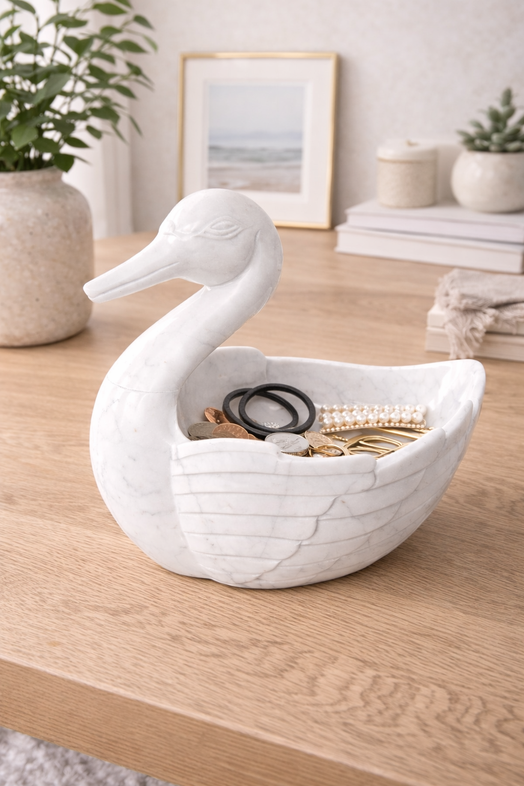 Hand-carved marble duck bowl holding hair accessories on bedside table, elegant home organiser NZ