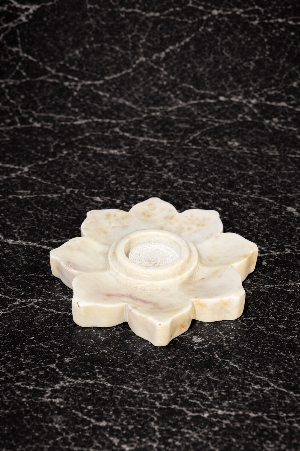 Solid white marble flower tealight holder on dark marble surface NZ