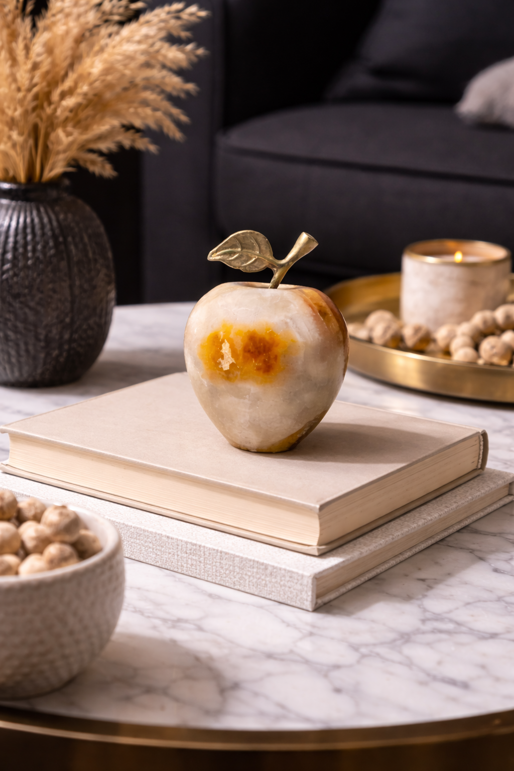 0.183 kg Onyx apple decor with metal leaf stem on stacked books beside a candle