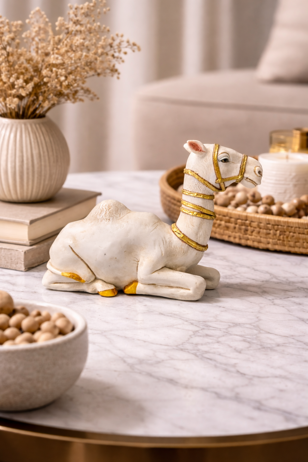 Luxury camel figurine in white with gold details on living room table