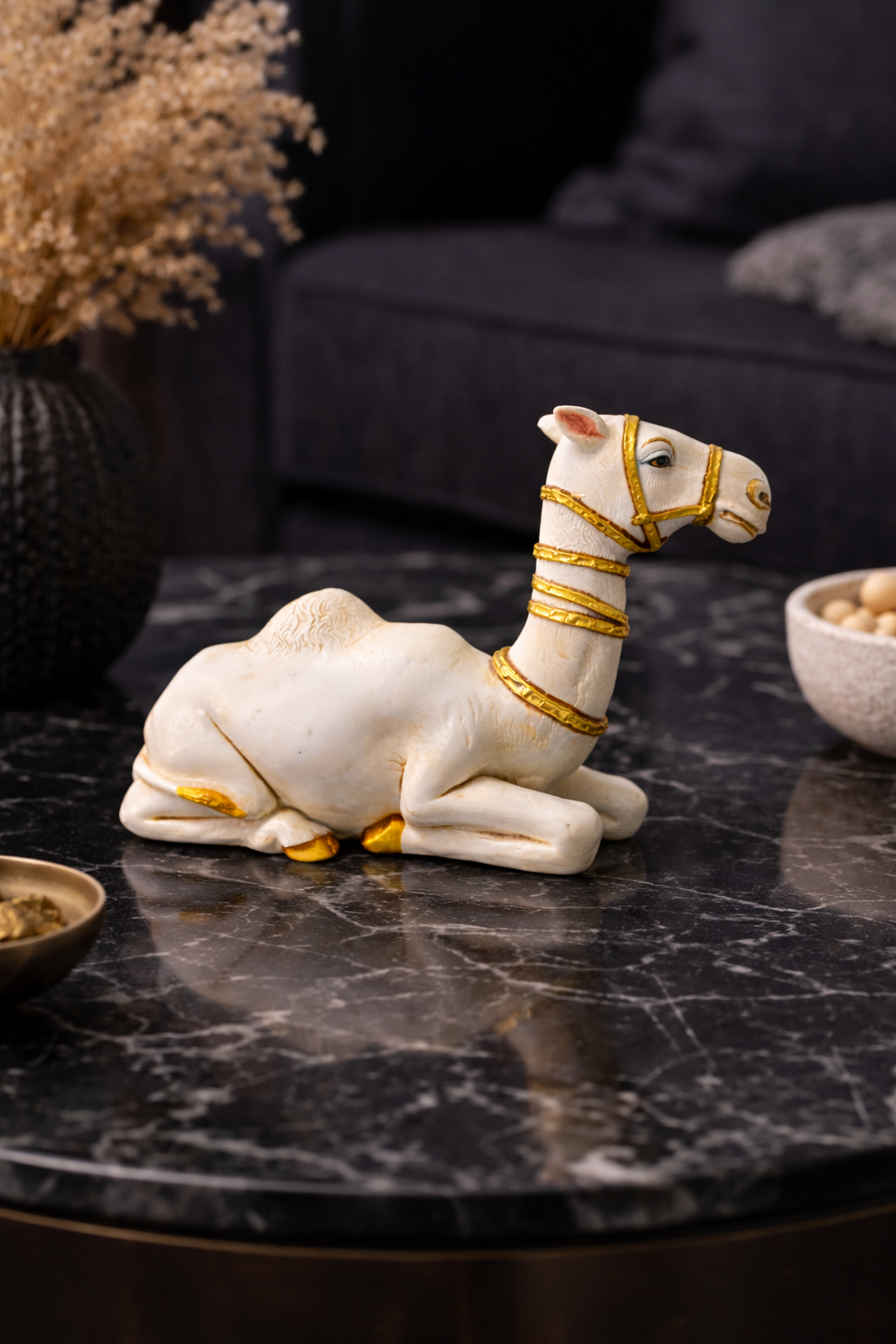 2.43 kg White camel figurine with gold accents on a dark marble coffee table