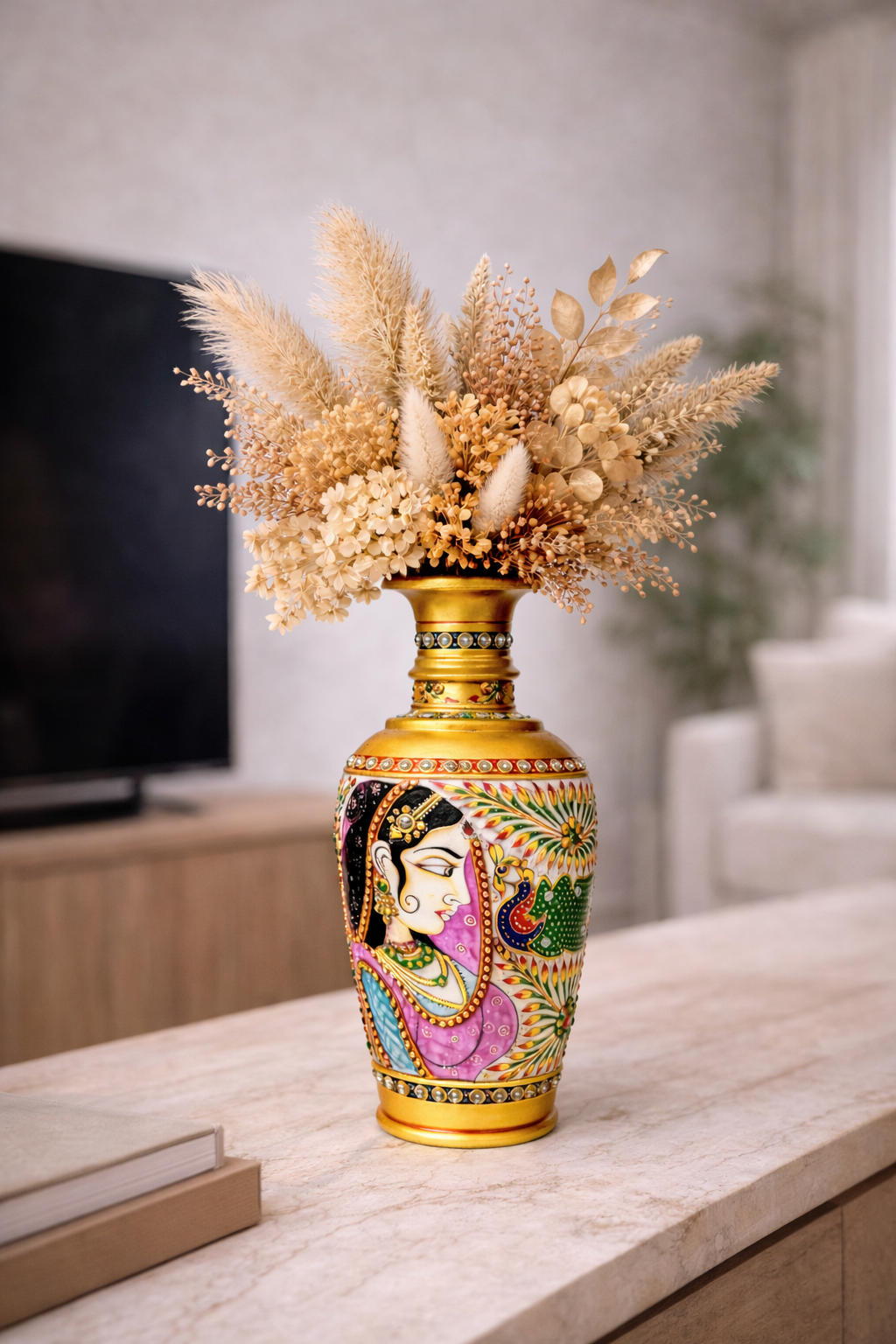 Hand-painted decorative vase with dried flowers on a countertop