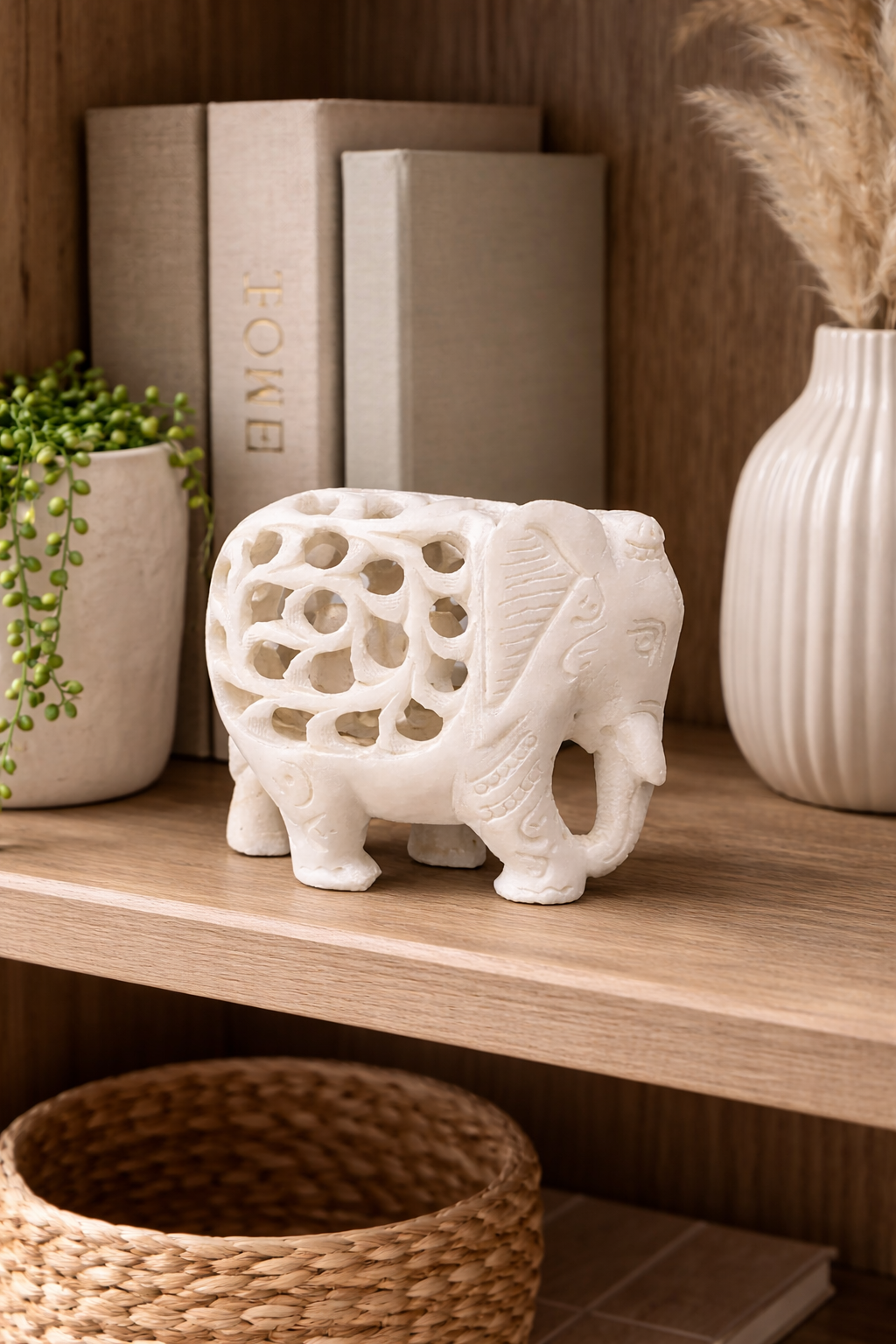 Hand-carved marble elephant with baby sculpture styled on wooden shelf NZ