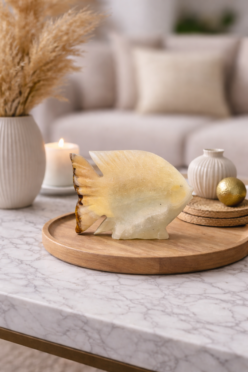 Hand-carved onyx fish sculpture styled on living room console table