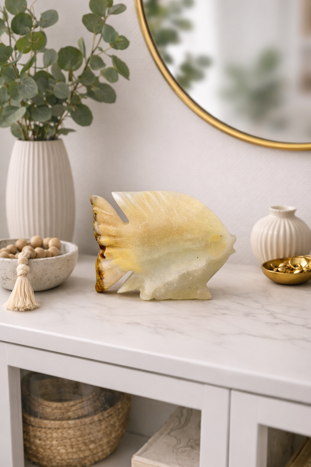 Polished onyx fish stone sculpture in modern home setting