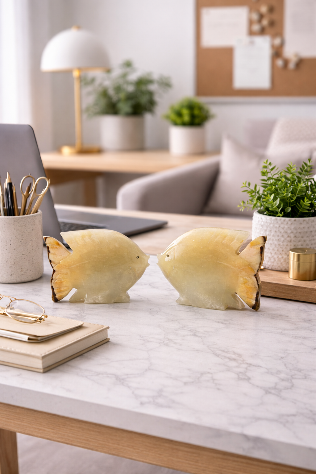 Polished onyx fish stone sculpture in modern workspace