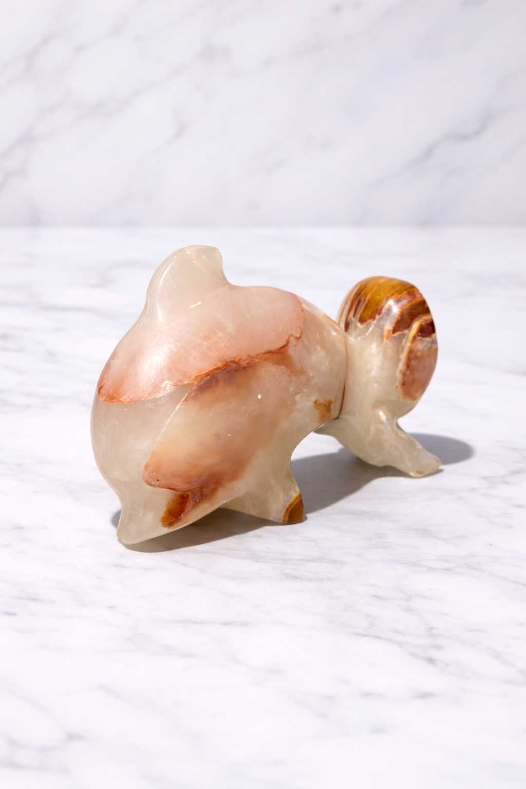 0.328 kg Natural onyx dolphin figurine with warm orange veining