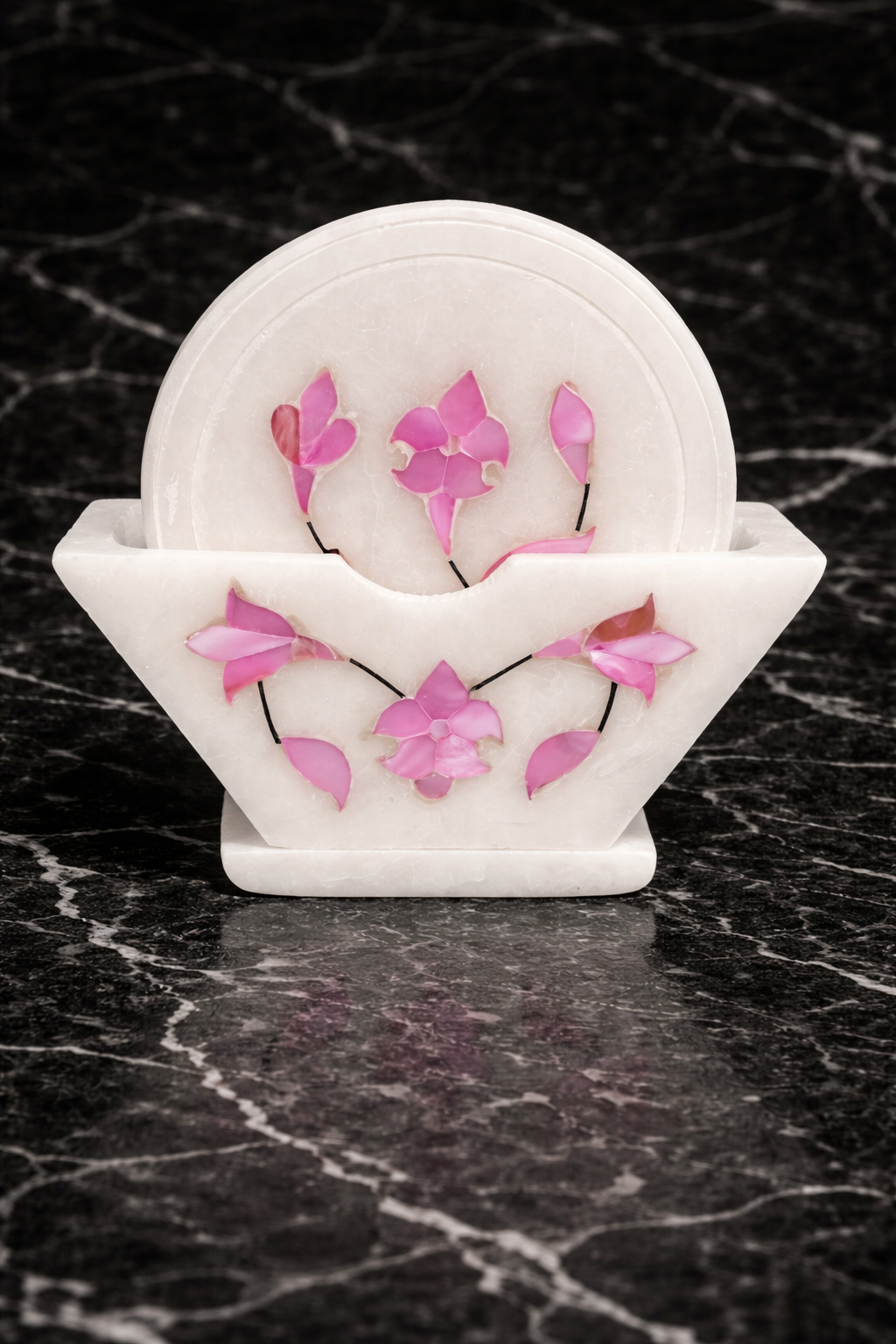 Close-up of handcrafted marble coaster with pink mother of pearl floral inlay – luxury stone drink coaster