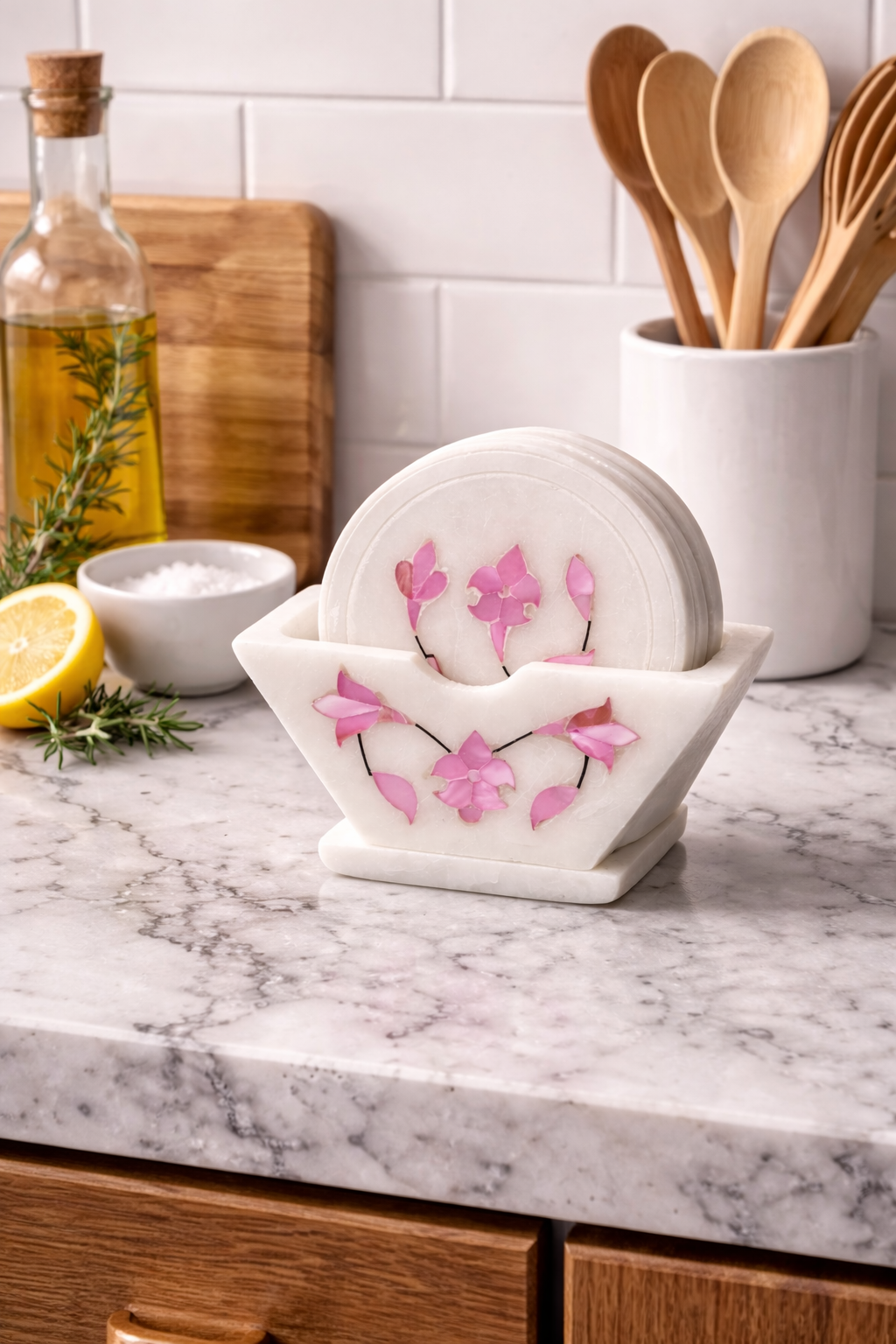 Decorative marble coaster set with floral inlay on black marble kitchen countertop – luxury kitchen decor accessory