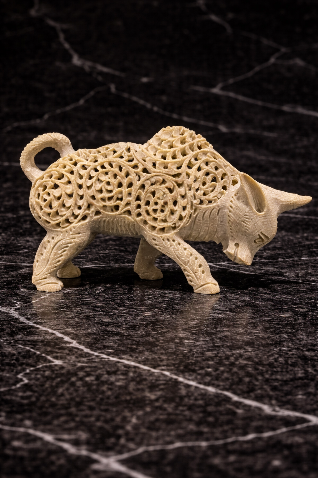 Intricately carved soapstone bull figurine with floral lattice design and baby bull inside – handmade stone sculpture