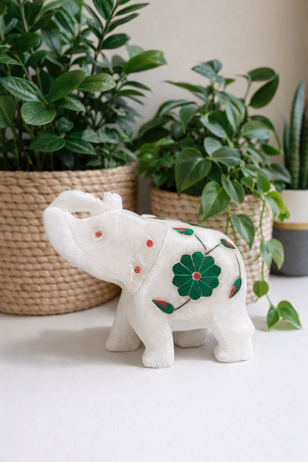 Luxury white marble elephant figurine with green floral inlay displayed beside indoor plants, elegant natural stone home decor nz
