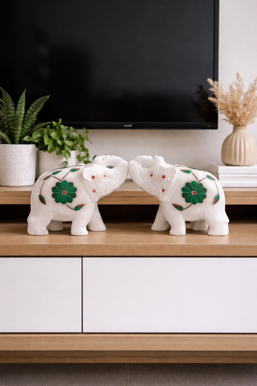 Pair of white marble elephant figurines facing each other on TV stand, luxury natural stone elephant decor for living room