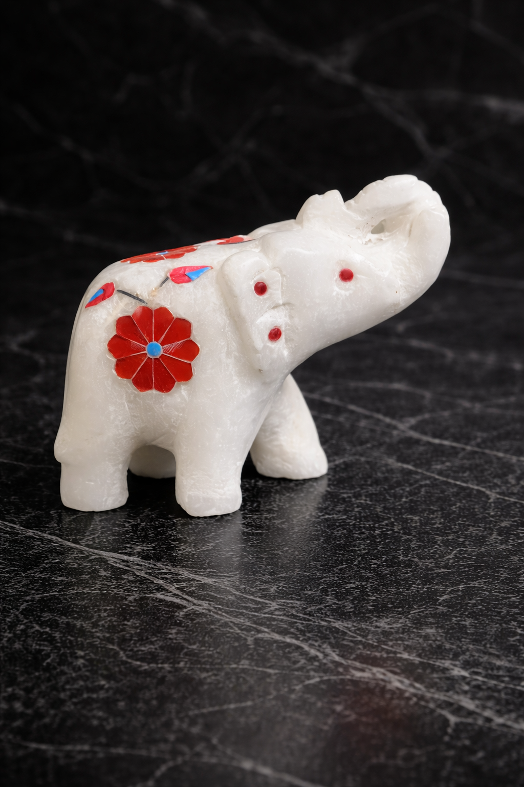 0.186 kg small white marble elephant statue with floral inlay detail black background