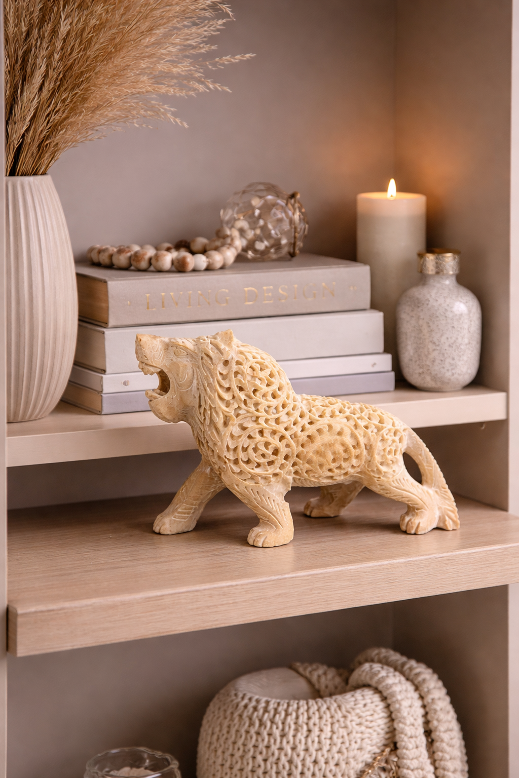 soapstone lion statue on wooden shelf decor luxury home styling nz with books candle and vase