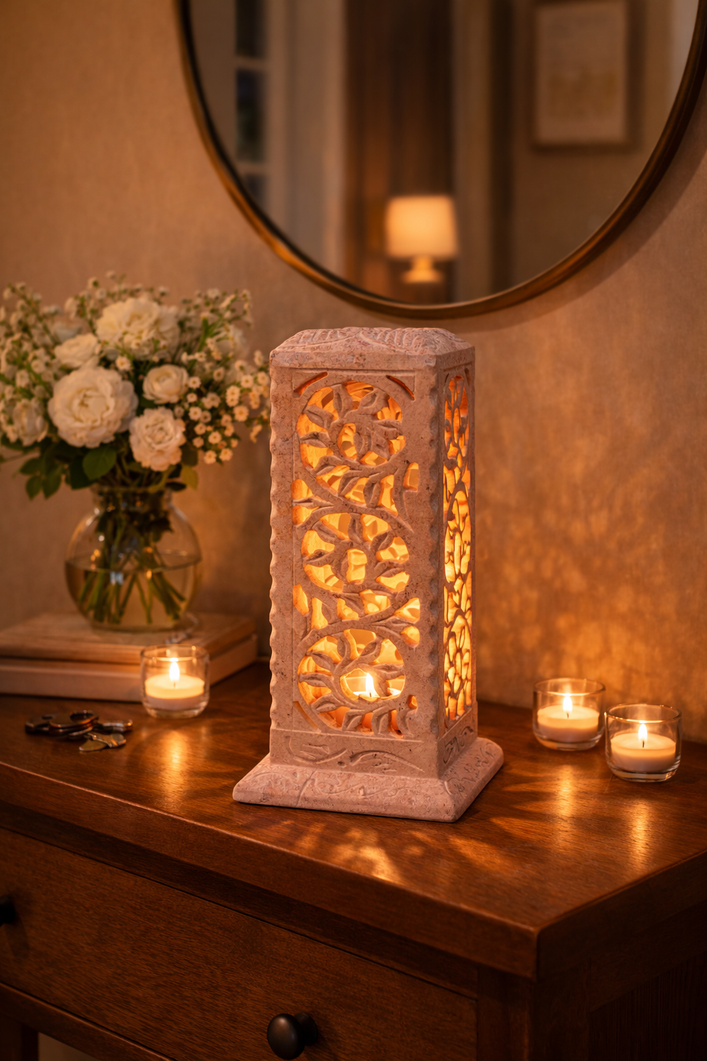 soapstone candle lantern on entry console table with round mirror and flowers luxury hallway decor nz