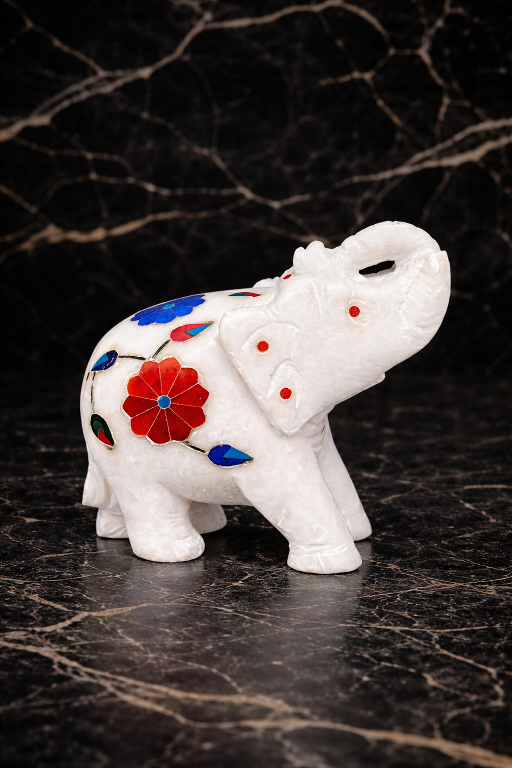 side view of hand carved marble elephant figurine floral inlay stone craftsmanship 
