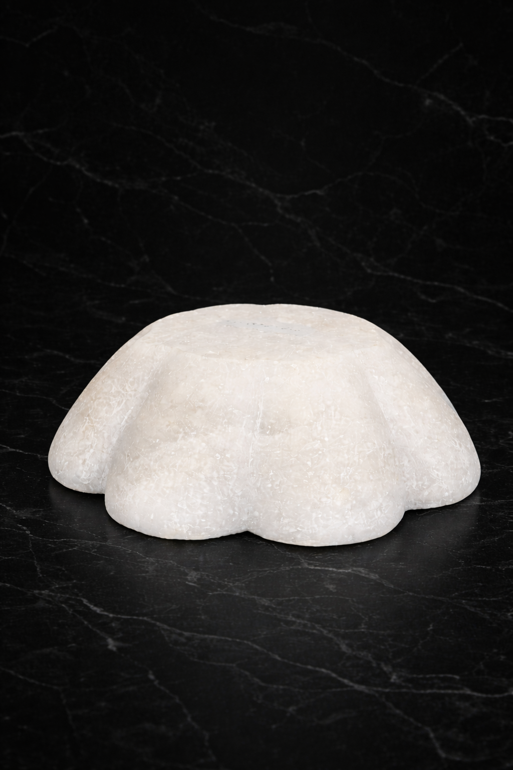 White marble lotus bowl base on black marble background – hand-carved decorative marble bowl