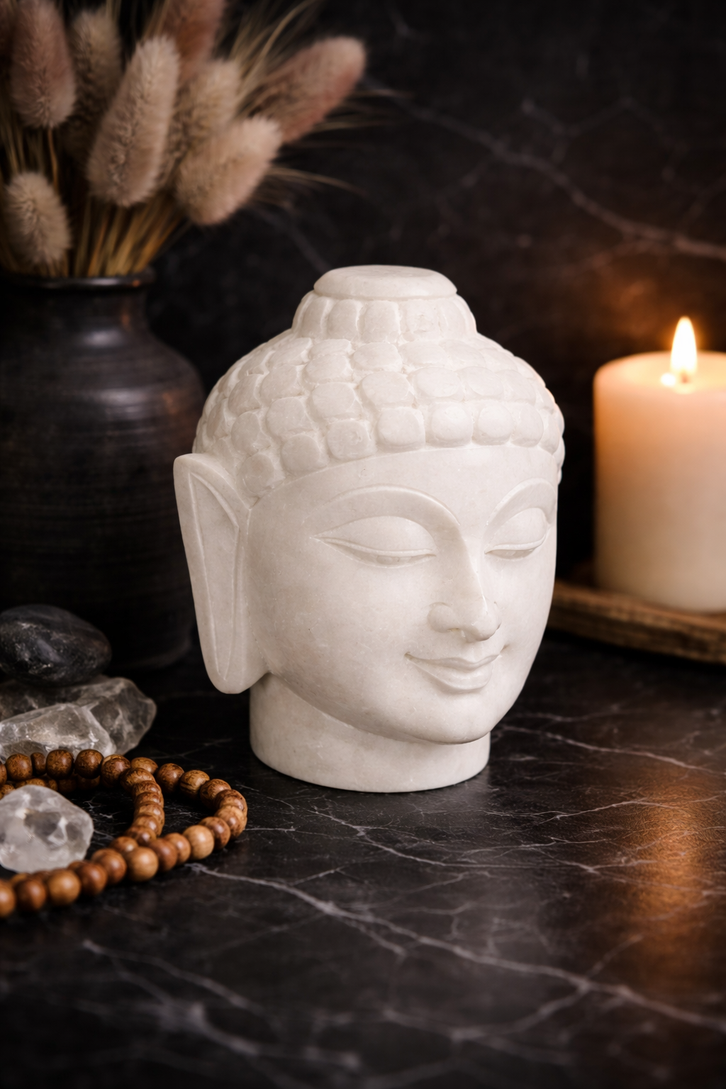 Zen decor marble Buddha head statue displayed on black marble table with candles