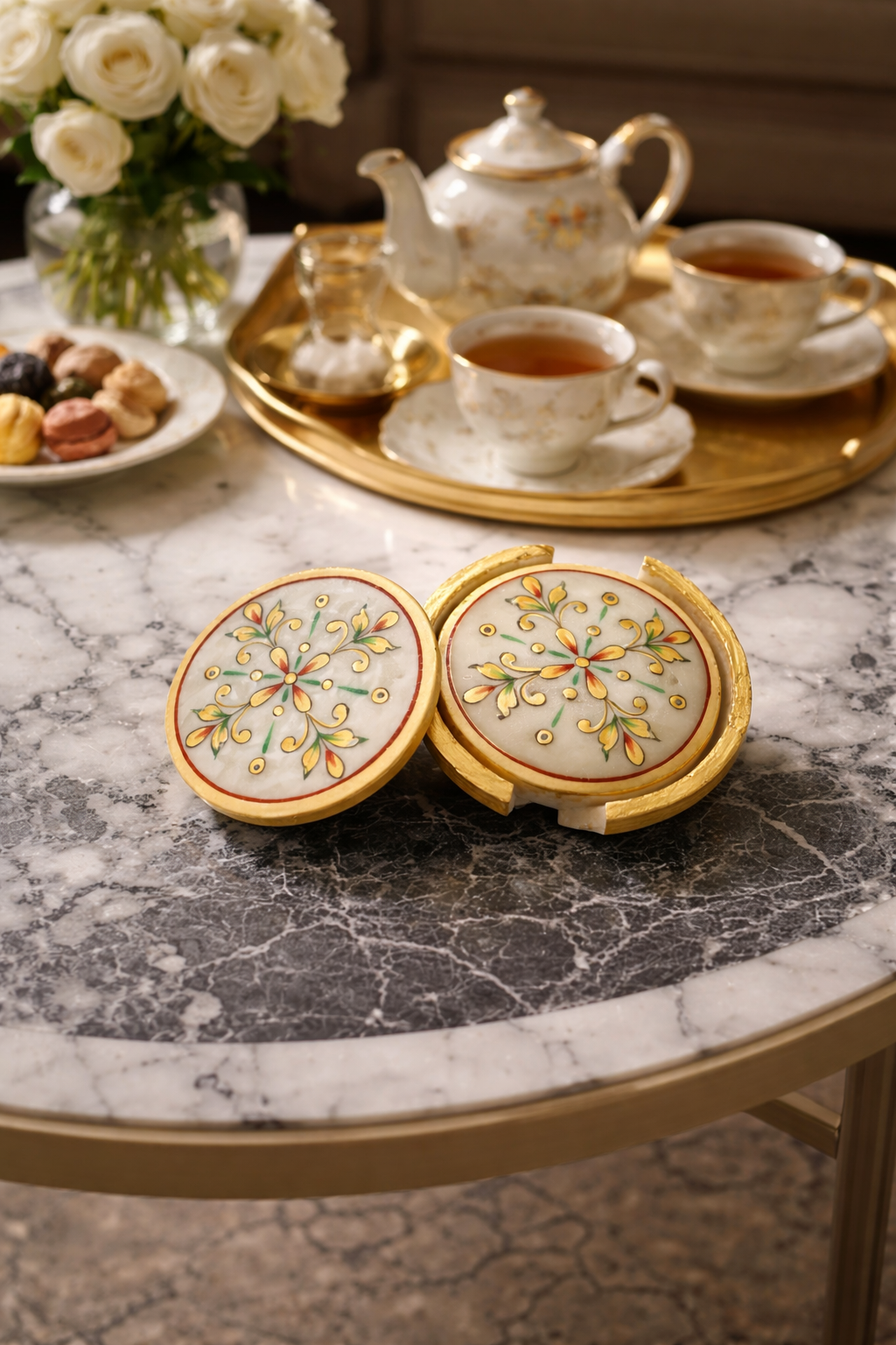 Luxury hand painted marble coaster set with floral pattern on a marble table with teacups and teapot.