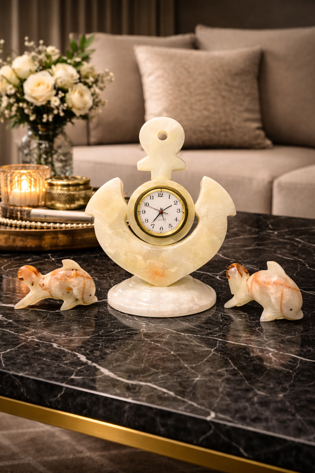 Hand-carved onyx dolphin figurines with marble anchor clock displayed on black marble coffee table in luxury living room décor setting nz