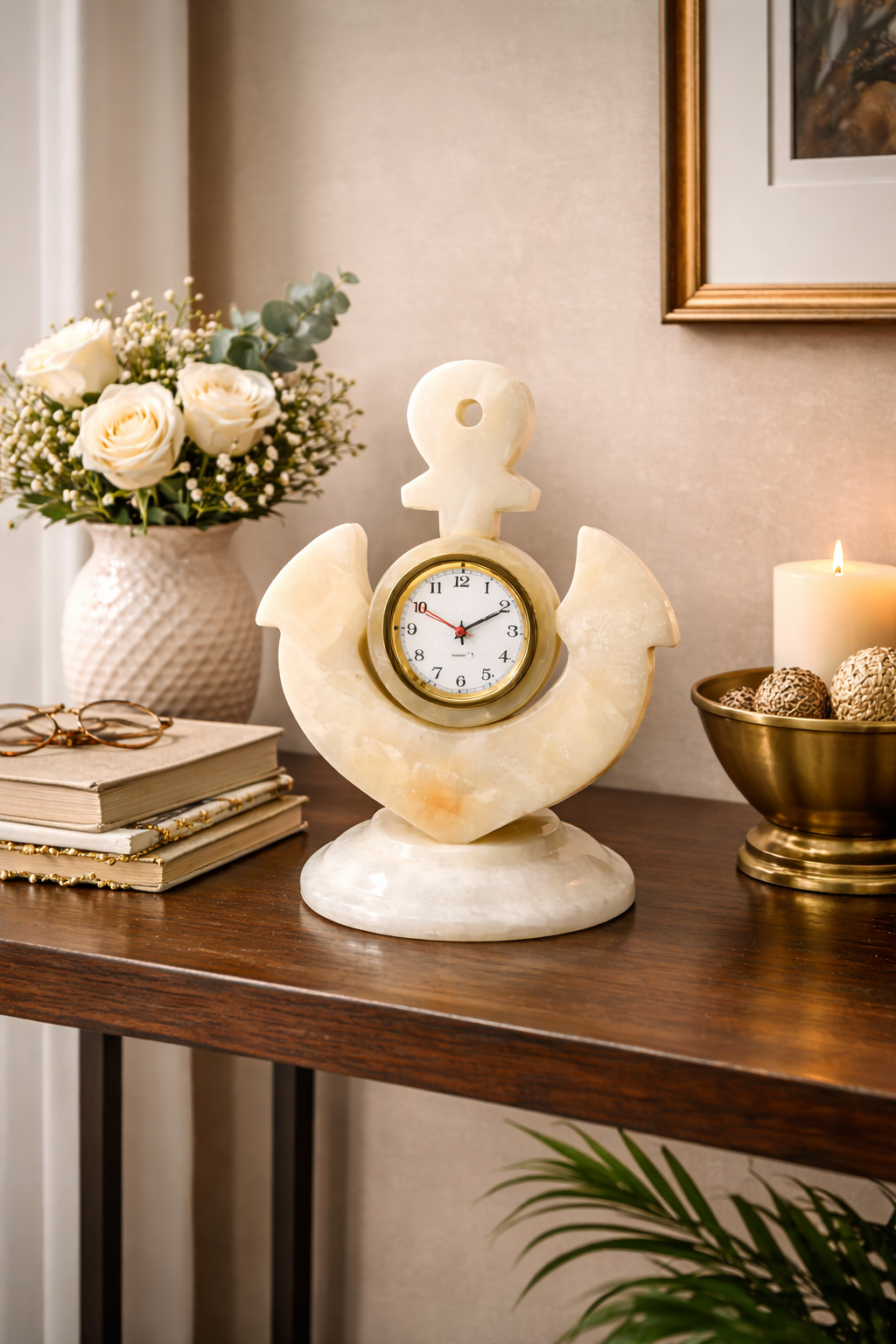 Luxury white marble anchor desk clock styled as decorative home décor on a wooden console table with flowers, books, and candle.